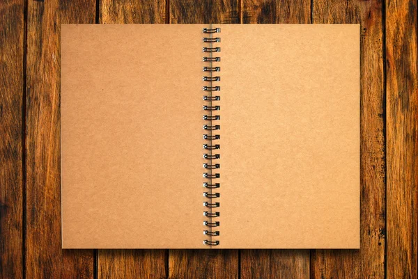 Blank notebook open on wood background