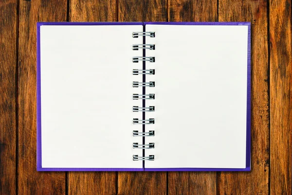 Blank purple cover notebook on wood