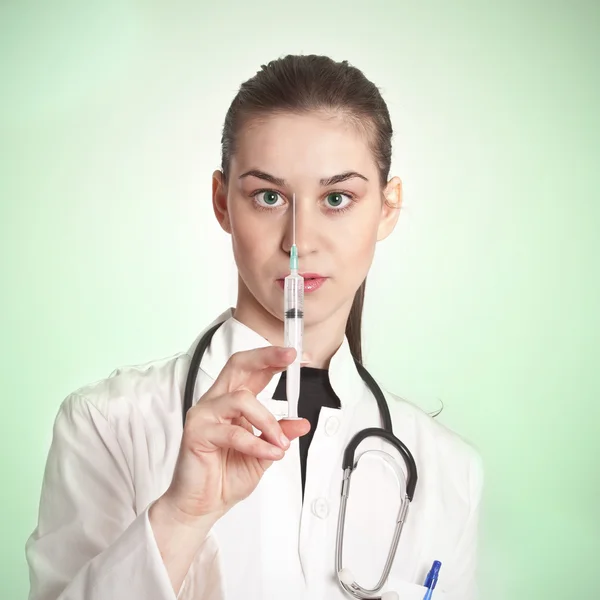 Doctor woman with medical syringe in hands