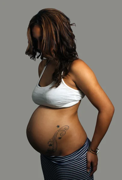 Woman Eight Months Pregnant with Tattoo