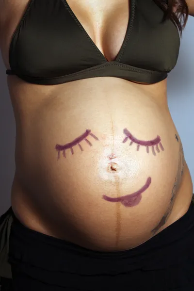 Child-like Smiley Face on Pregnant Woman