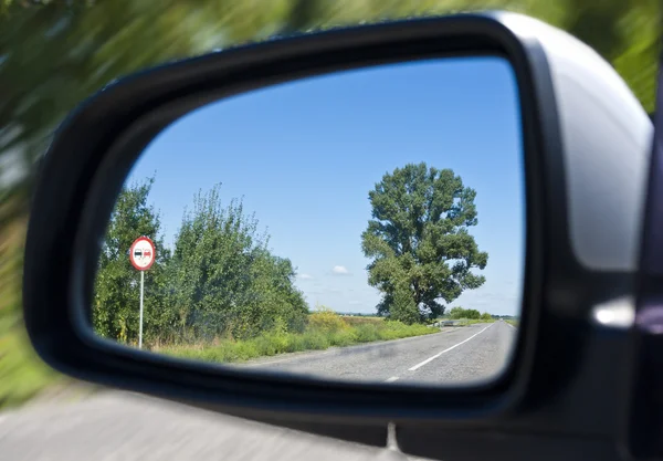 Road in the car mirror