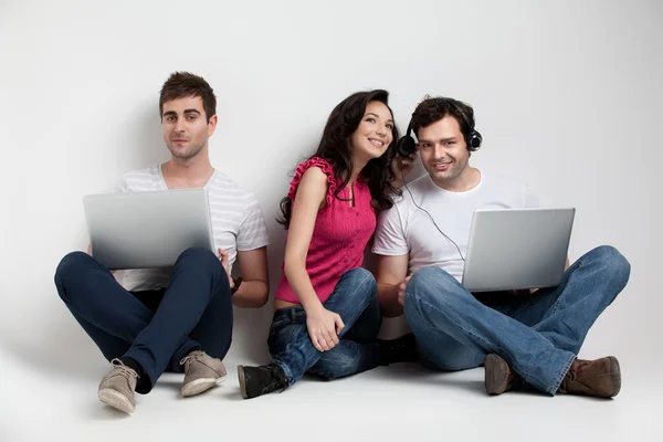 Three friends holding laptops expressions — Stock Photo #5803358