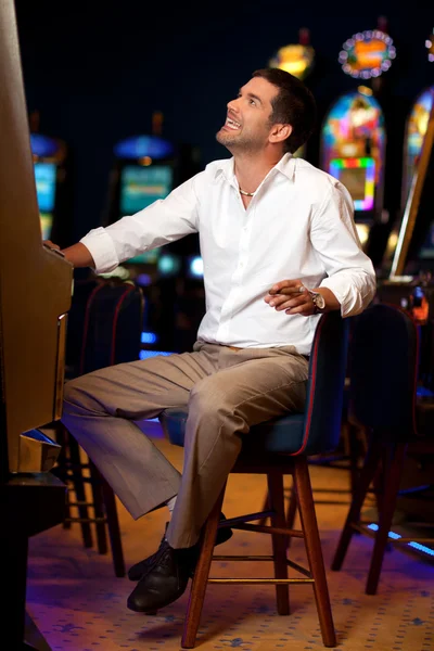 Handsome man at the slot machine