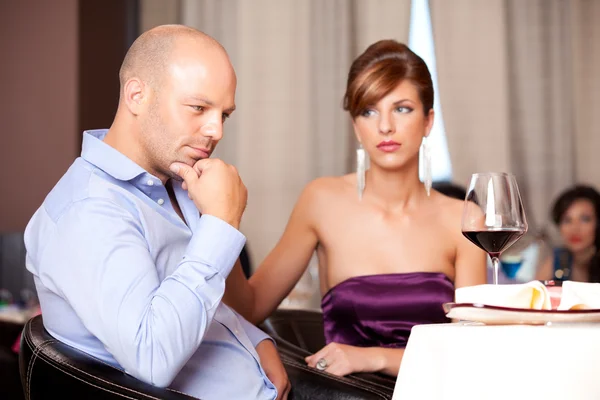 Couple having an argument at restaurant table