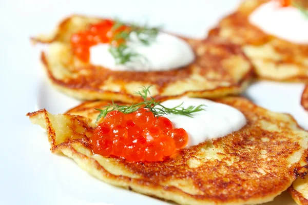 Potato pancakes with red caviar