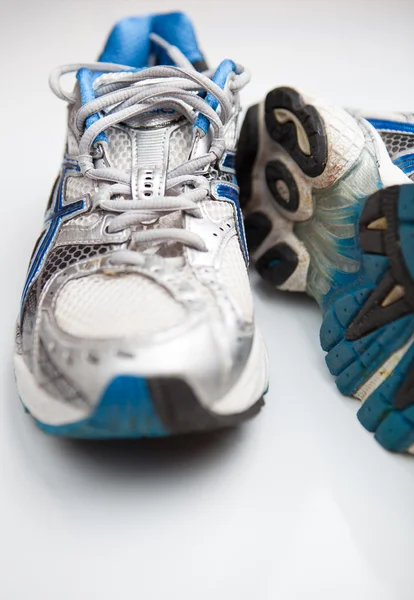 Pair of running shoes on a white background (shallow DOF; color