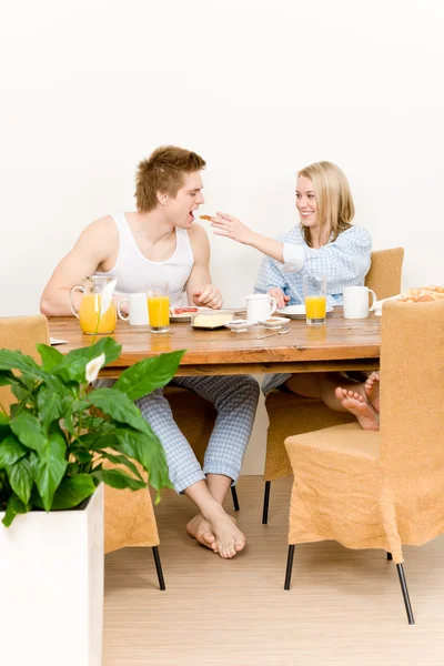 Breakfast happy couple woman feed man toast