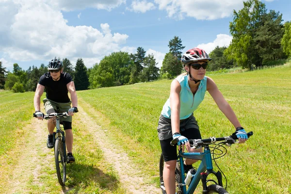 sport happy couple riding bicycles in coutryside