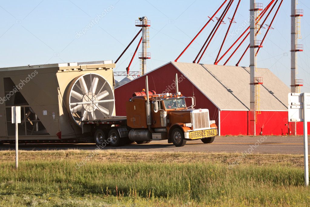 Truck hauling grain drying bin in scenic Saskatchewan — Stock Photo