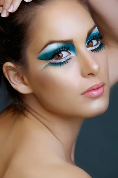Woman with turquoise make-up.