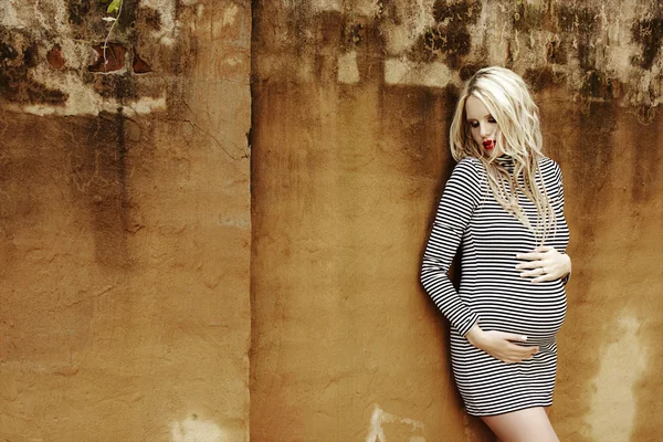 Beautiful eight months pregnant blond woman