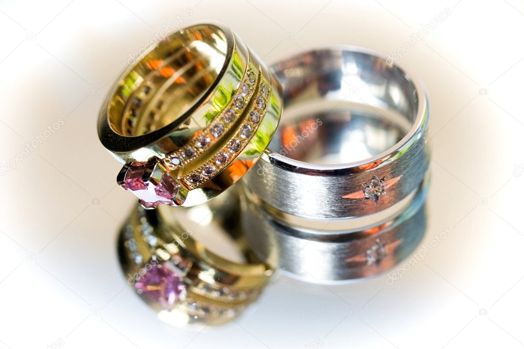 His and hers wedding rings closeup on white backround