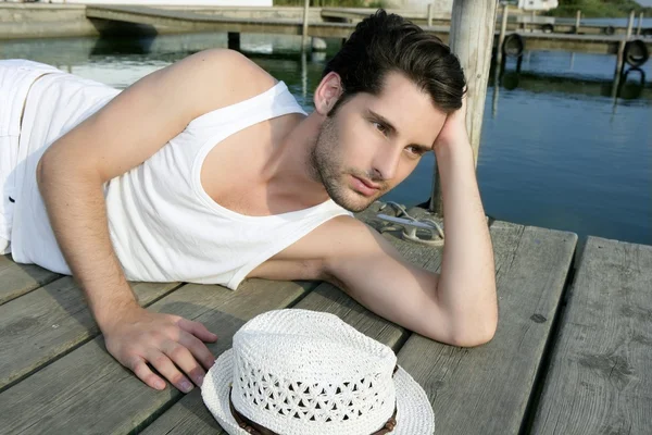Mediterranean young man relaxed on wood pier
