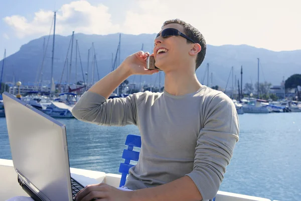 Businessman working with computer on a boat