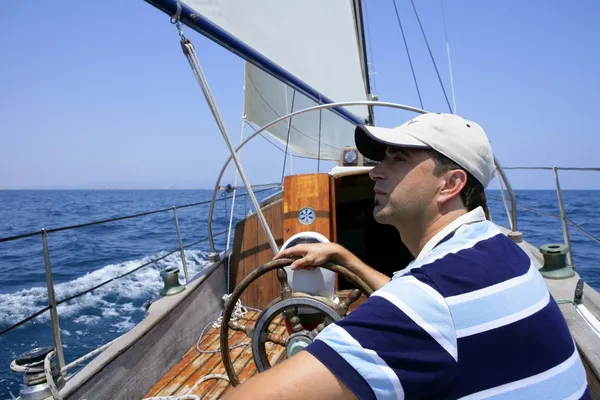 Sailor sailing in the sea. Sailboat over blue
