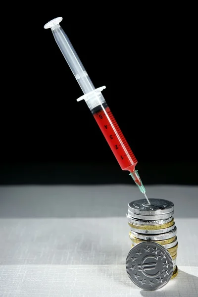 Euro currency syringe injection, financial metaphor