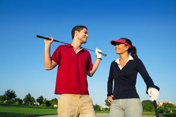 Golf course young happy couple players couple talking