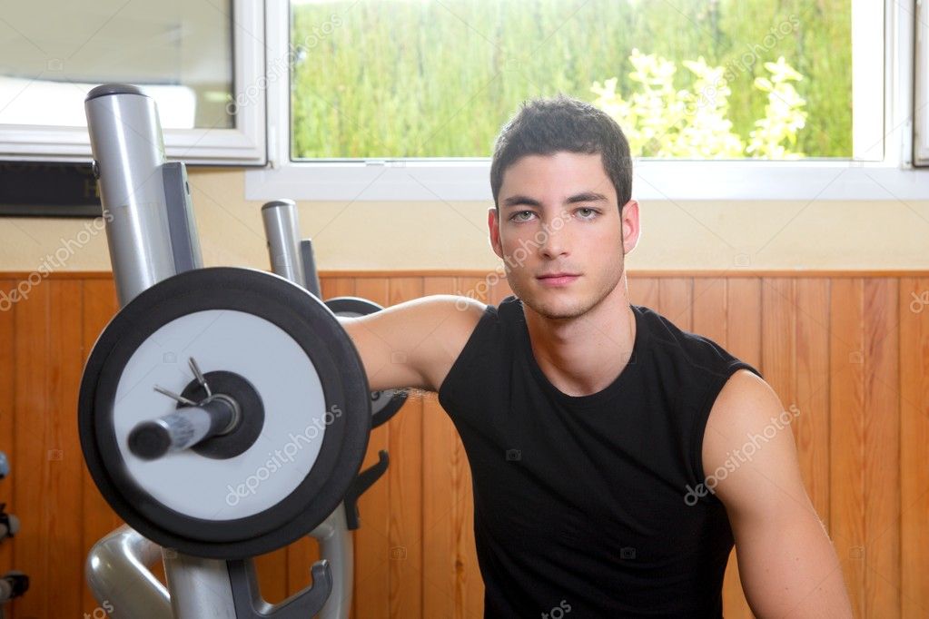 Gym young man posing body building weigths black