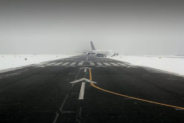 Airplane wing aircraft landing in snow winter runway