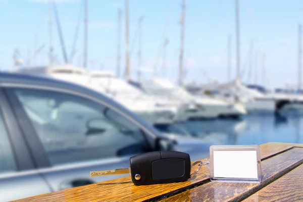 Car rental keys on wood table in Mediterranean vacation