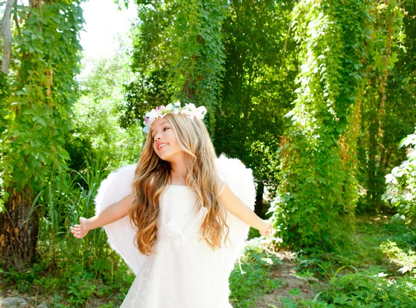 Angel children girl open arms in forest white wings