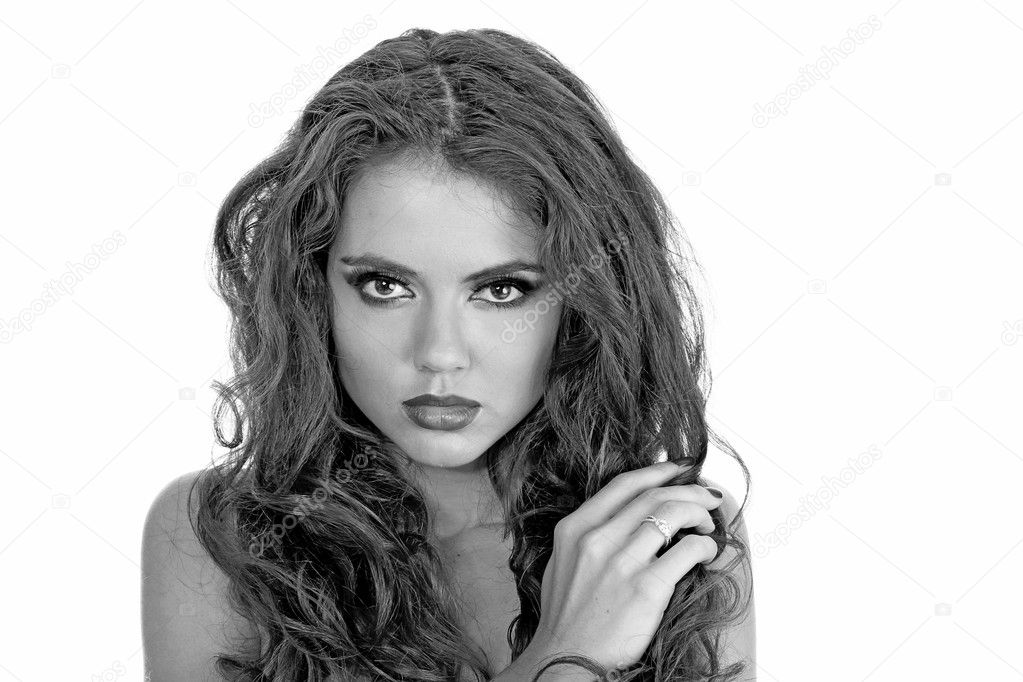 Portrait of Beautiful model with sexy lips and long curly hair