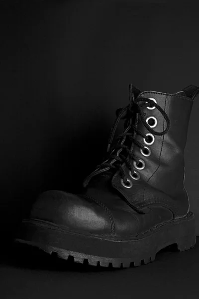 Boot on the black background