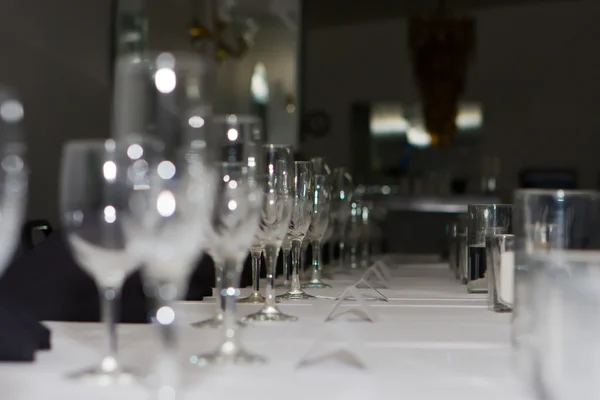 Wedding reception dinner table glasses lined up.