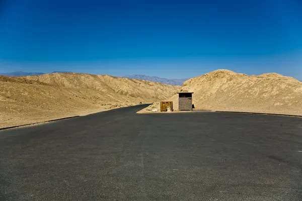 Scenic road Artists Drive in Death valley, empty parking place