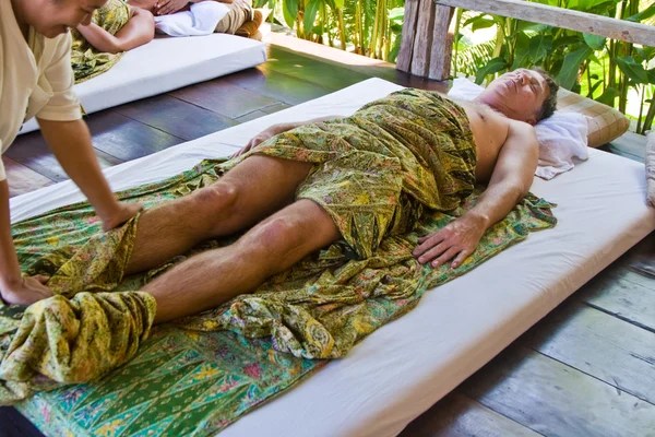 European man gets a healthy massage in thailand and enjoys it