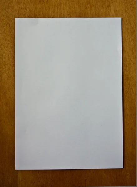 New blank paper page on wood background vertical