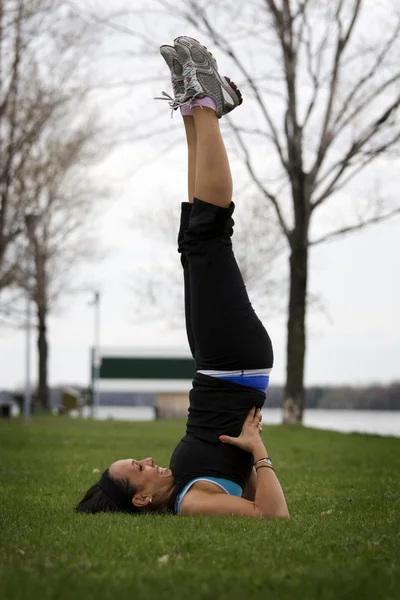 Young girl doing aerobics in park by Charles Knox Stock Photo