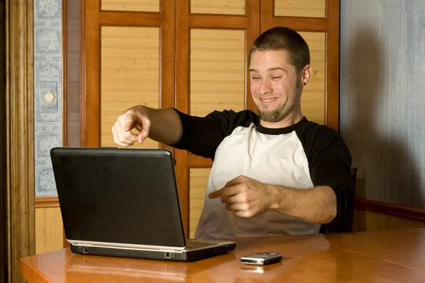 Happy man pointing at computer screen