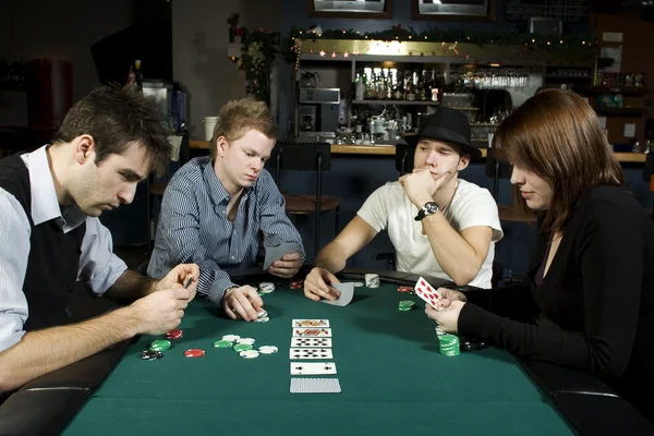 Four friends playing poker