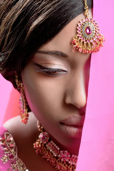 Beautiful indian woman wearing golden jewelry
