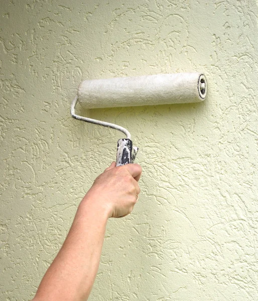 Roller with paint on the wall