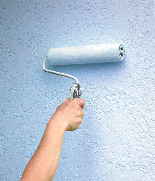 Roller with paint on the wall