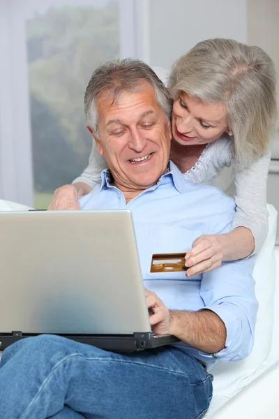 Senior couple doing online shopping