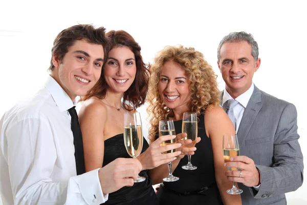Group of friends cheering with glasses of champagne
