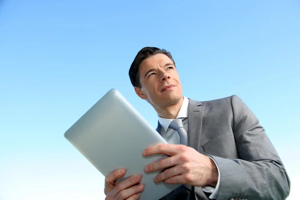 Portrait of businessman working on electronic tablet