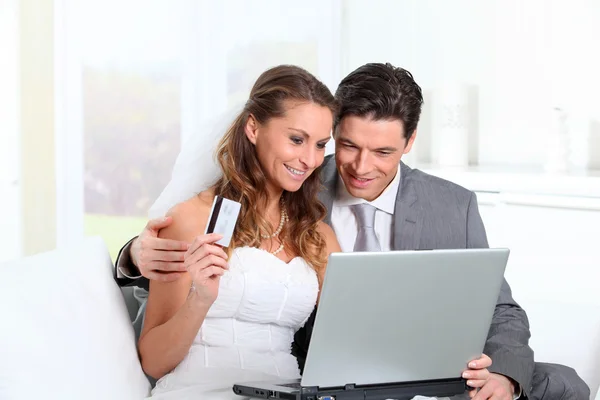Bride and groom doing shopping on inernet