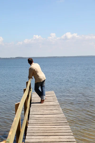 Man on a pontoon by a lake