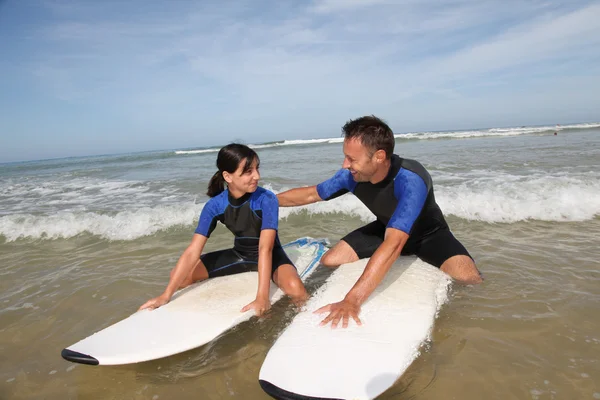 Father and daughter surfing
