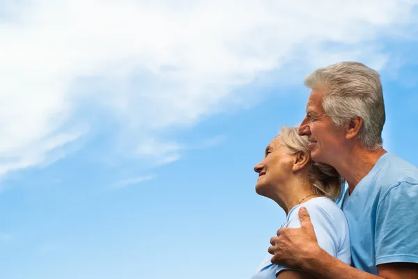 Aged couple on a sky background