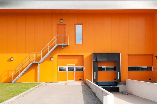 Orange building with loading dock and fire escape stair