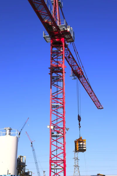 Heavy duty cranes on worksites.