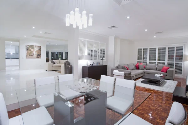 Luxurious dining room with living rooms and kitchen in the backg