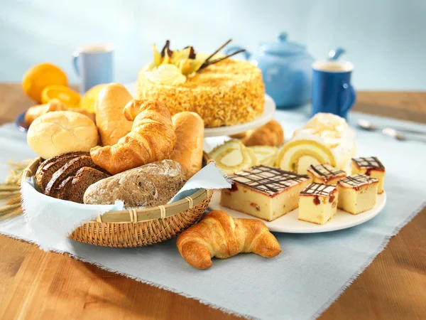 Bread and dessert arrangement on table