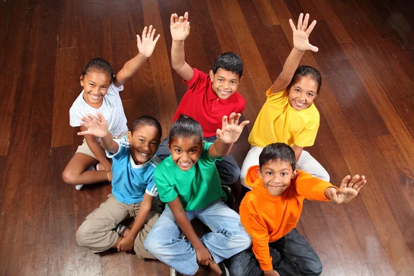 Six school children on classroom floor